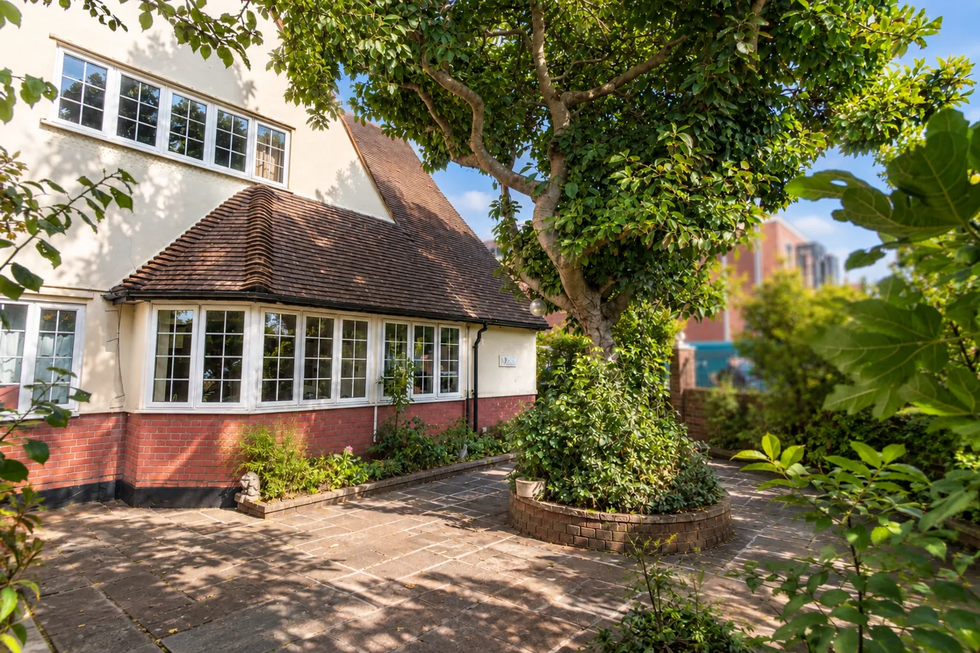 House and paved front garden of a property marketed by Dwelling & Manor